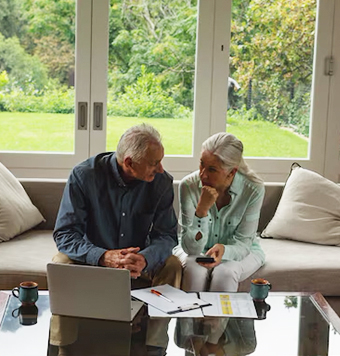 active-senior-couple-calculating-bills-living-room_13339-350324-2